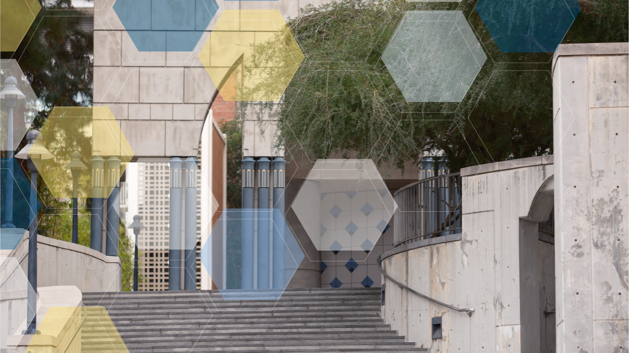 Grey art-deco building, featuring its staircase with blue, yellow, and white molecule overlay