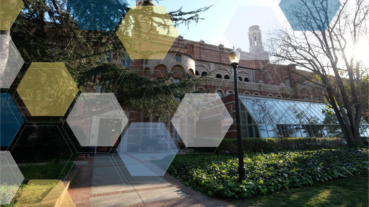 A red brick building with a glass sunroom and blue, yellow, and white molecule overlay