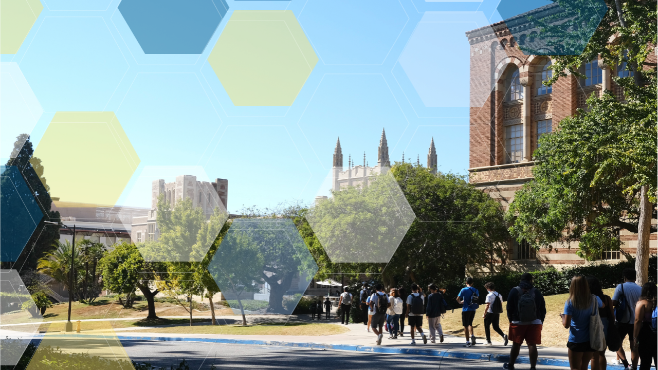 Students walking past gothic brick buildings partially obscured by green trees.