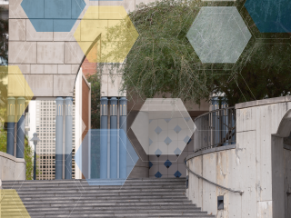 Grey art-deco building, featuring its staircase with blue, yellow, and white molecule overlay