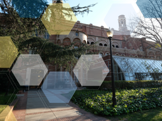 A red brick building with a glass sunroom and blue, yellow, and white molecule overlay